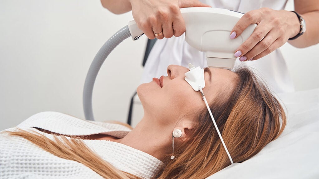 Woman receiving a laser hair removal treatment on the face at Image Maker Aesthetics Miami